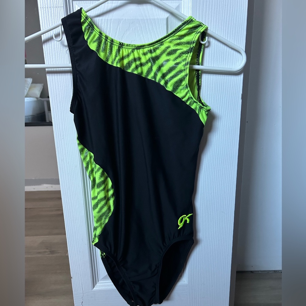 Bright green and black GK gymnastics leotard.
